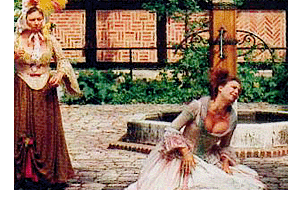 Billede fra holbergspillene, mascarade, af to kvinder iført kjoler, i dramatisk positur på en gårdsplads.
